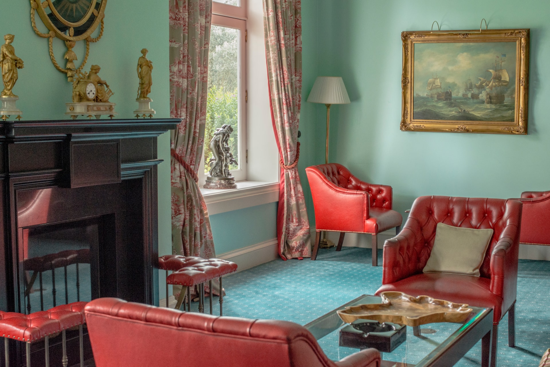 red sofa chair near fireplace